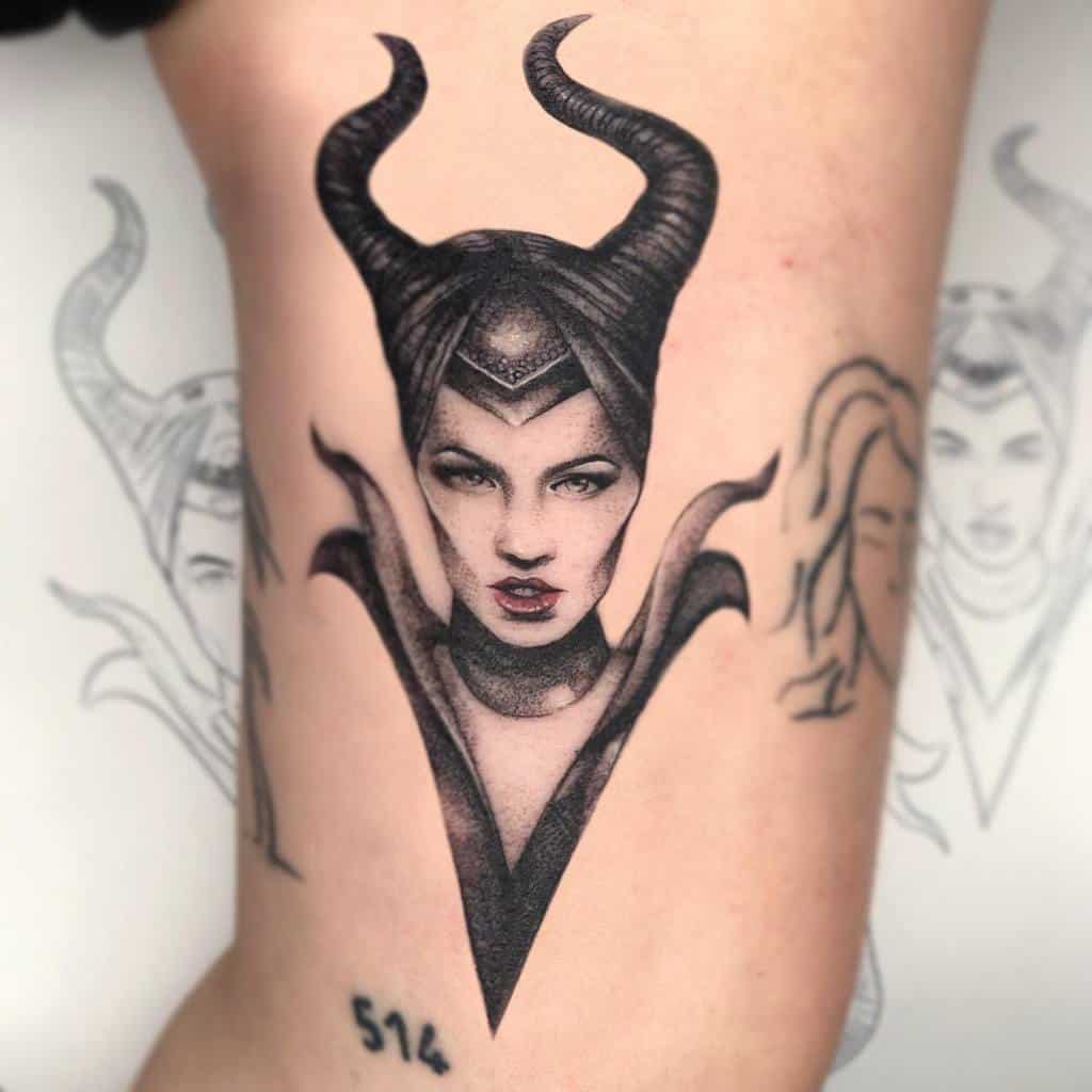 Striking black-and-gray tattoo of Maleficent with sharp details, featuring her iconic horns and dramatic facial expression