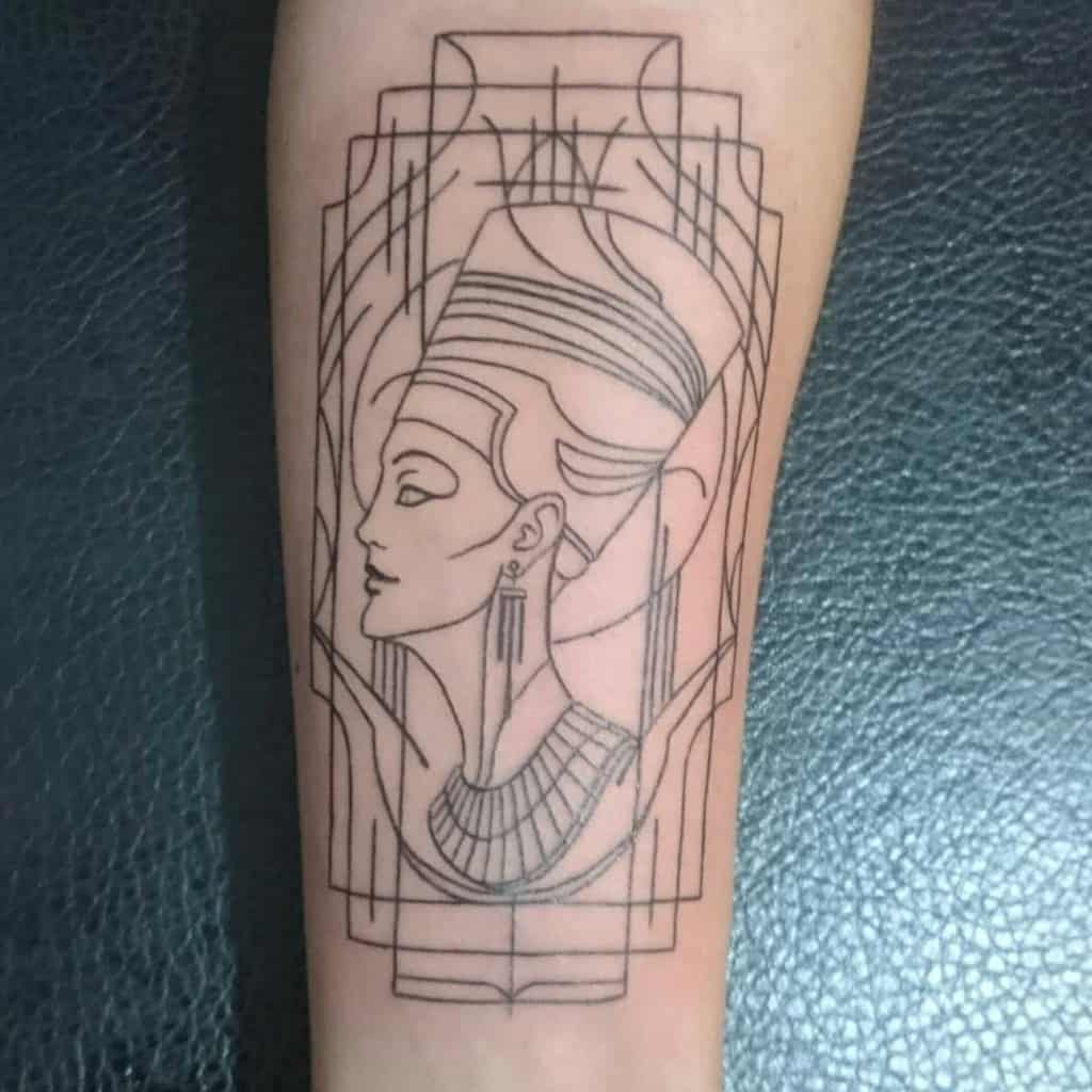 Line art tattoo of Queen Nefertiti with a headdress and earrings on a forearm
