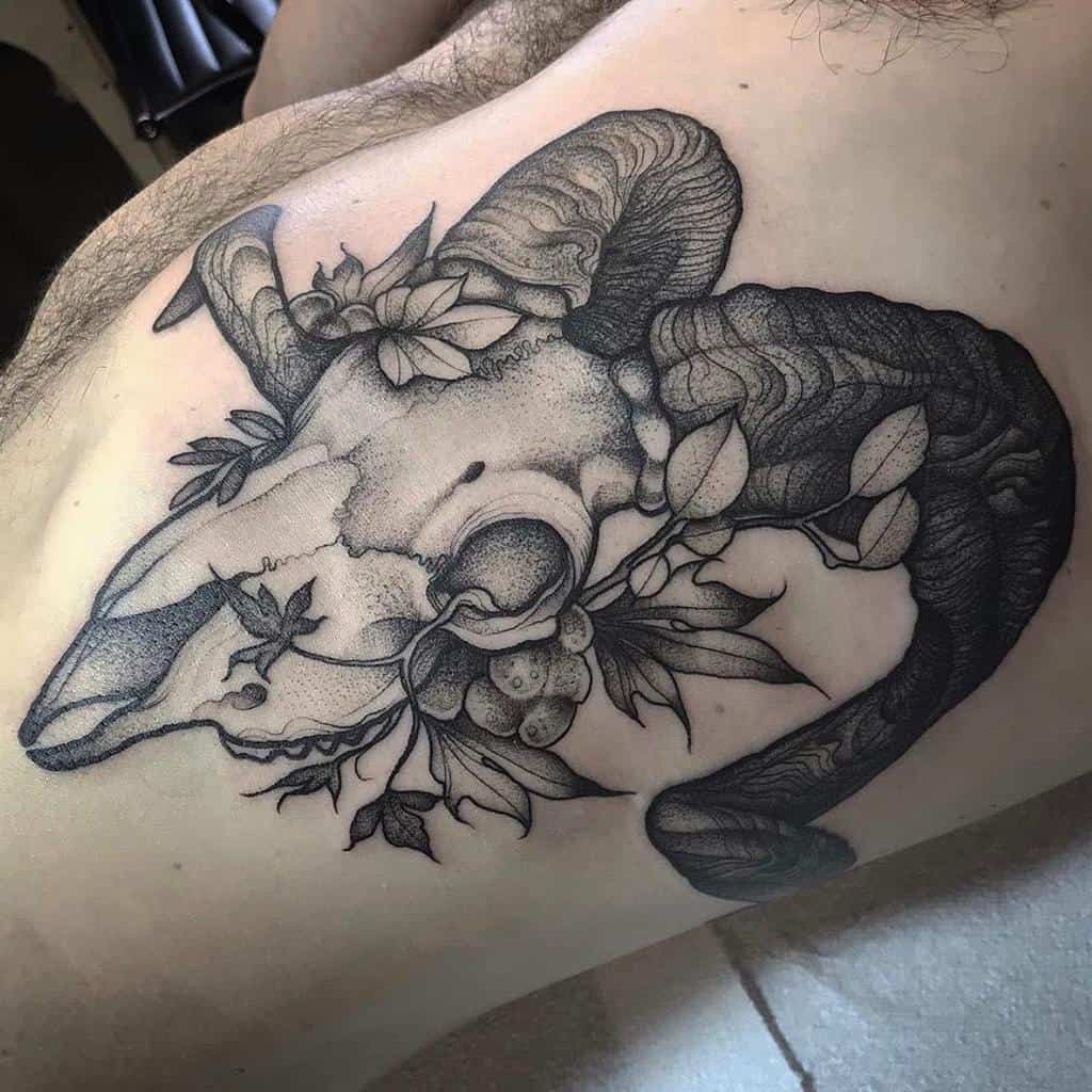 Tattoo of a ram skull intricately intertwined with foliage and vines on the side