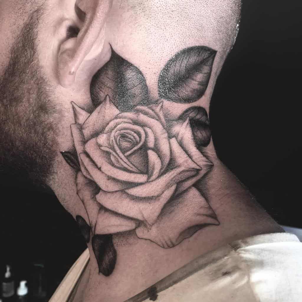 A detailed black and gray rose tattoo elegantly adorns the neck, with intricately designed leaves surrounding it for a striking effect