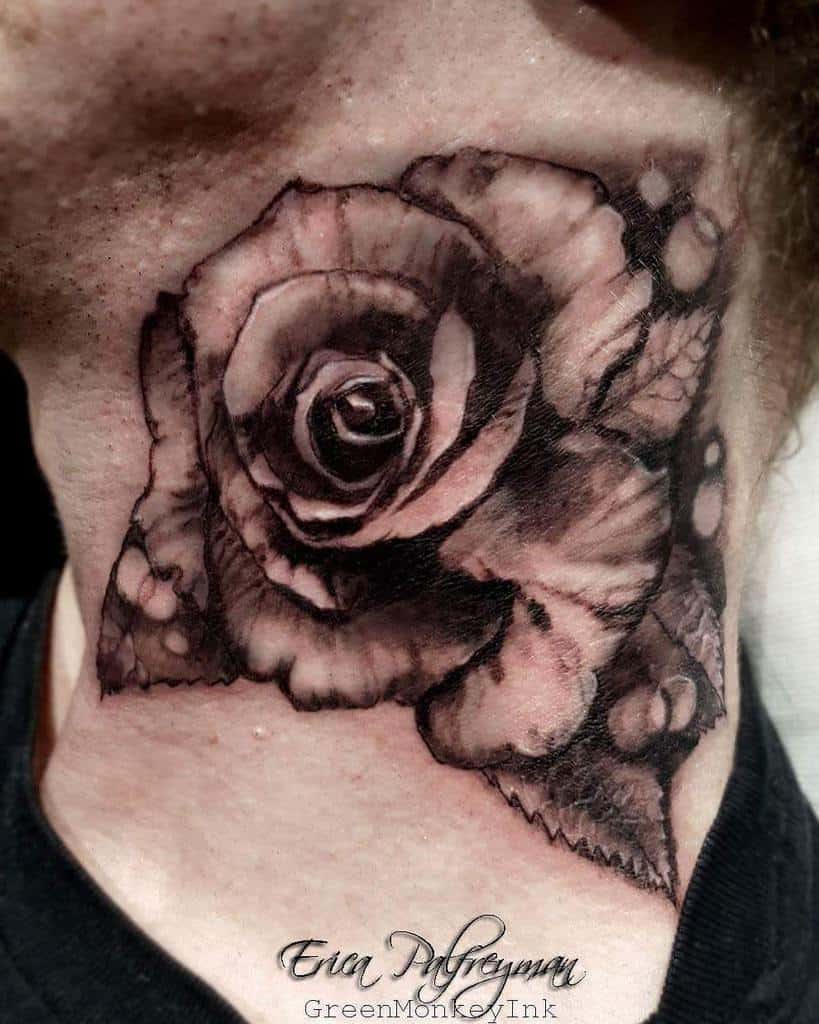 A striking black and grey rose tattoo elegantly adorns the curve of a person's neck, blending artistry with bold placement