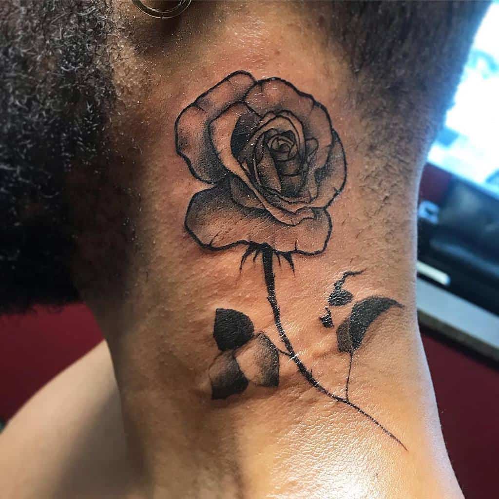 Blackwork neck tattoo of a rose with a long stem and leaves, featuring bold outlines and shaded details for a dramatic look