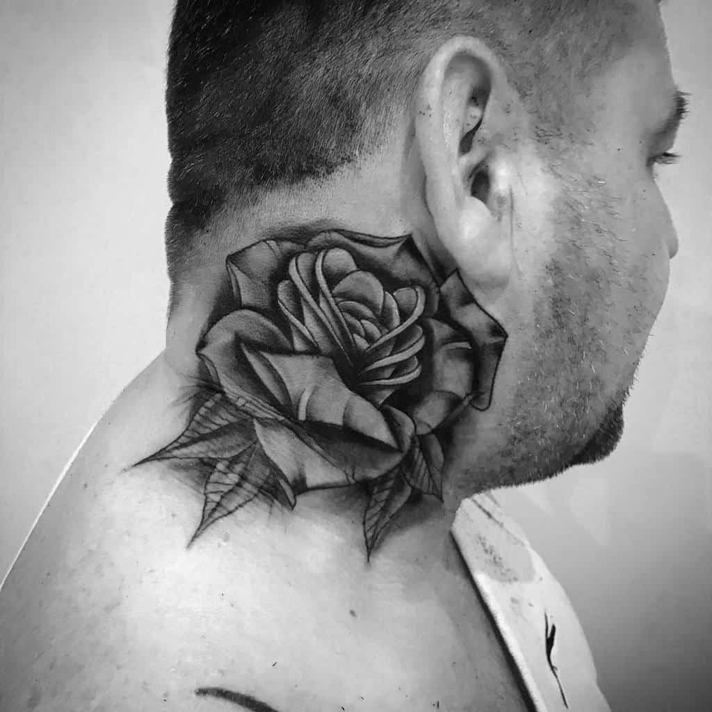 Black and white tattoo of a rose gracefully adorns the neck, blending elegance with artistry