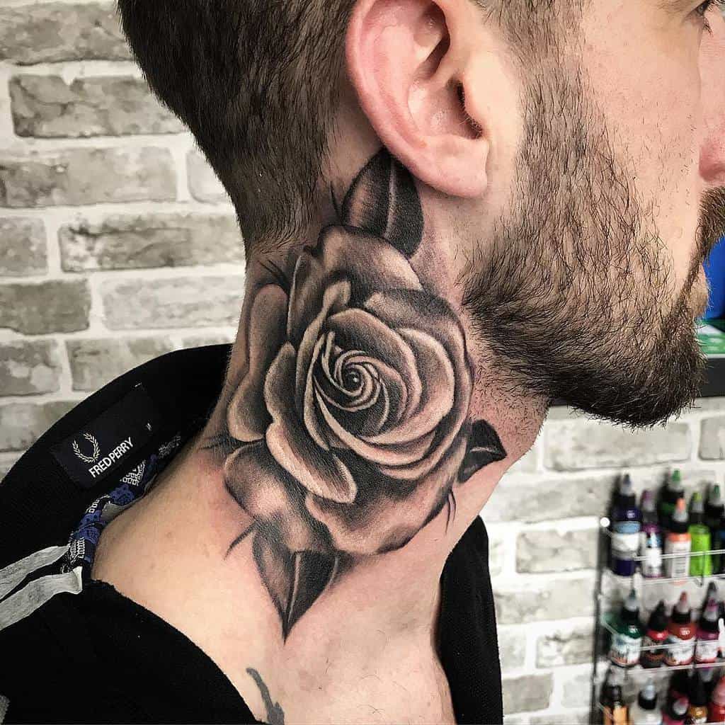 Black and grey rose tattoo on the side of the neck, featuring intricate shading and bold petal details for a striking look