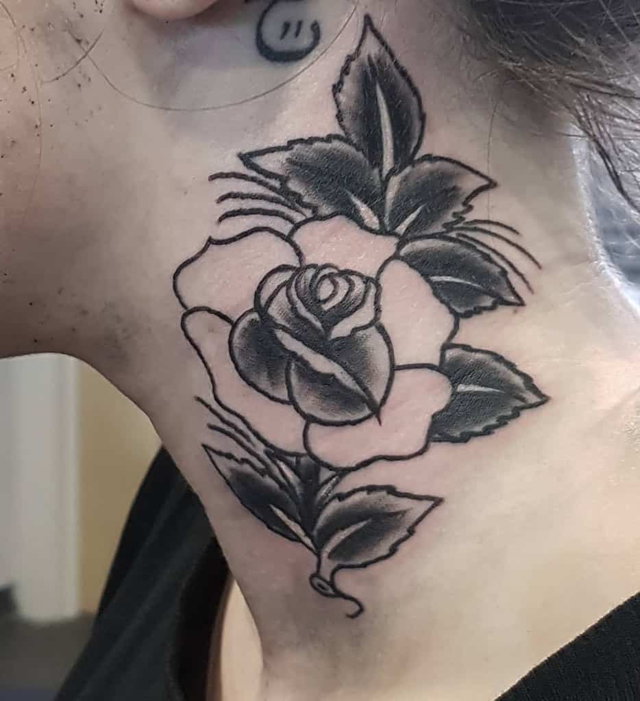A striking black and grey rose tattoo elegantly graces the neck, adding an aura of mystery and artistry