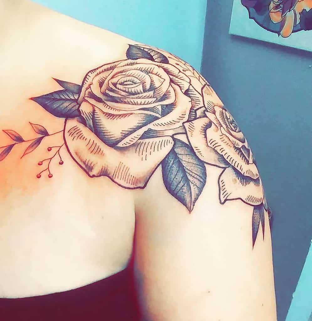A striking black and gray rose tattoo elegantly adorns the shoulder, its intricate details capturing both depth and allure