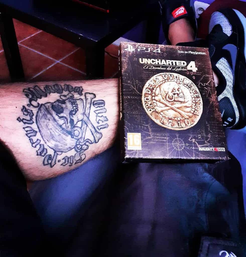 Leg tattoo featuring a pirate-themed design with 'Sic Parvis Magna' text, shown alongside the Uncharted 4 game box