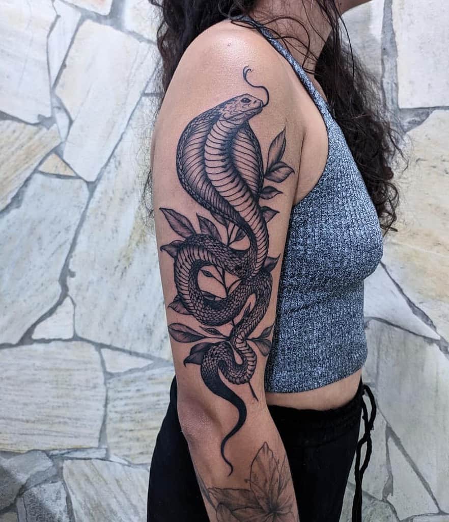 Woman with a detailed cobra tattoo on her arm