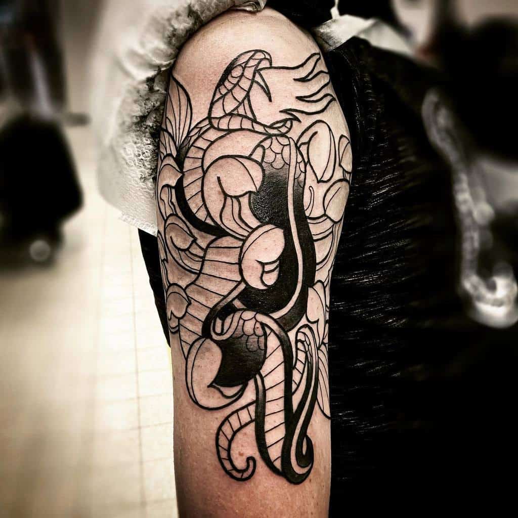 Bold blackwork tattoo of a snake with abstract patterns and flowing lines, wrapping around the upper arm