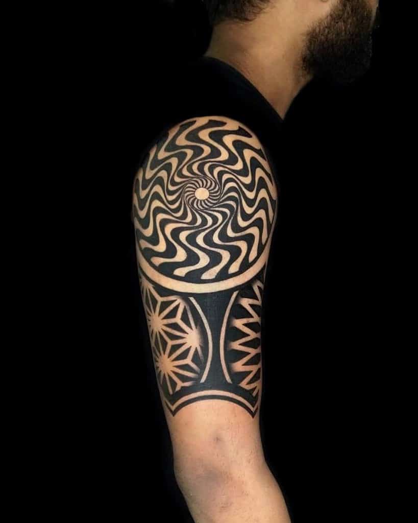 Intricate geometric and spiral tattoo design on an upper arm 