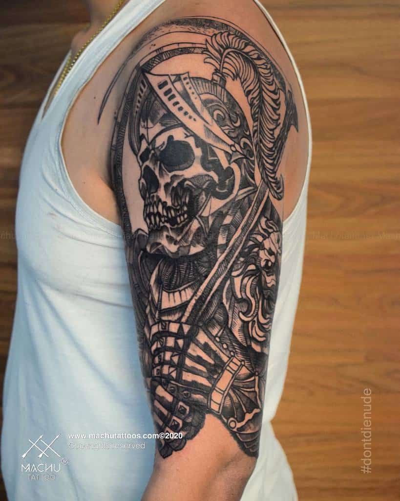 Arm tattoo featuring a detailed warrior skeleton with armor and intricate patterns