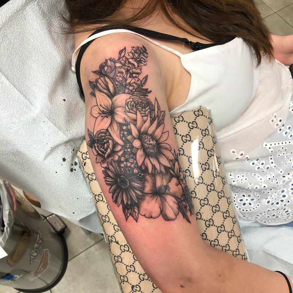 Woman with detailed floral tattoo covering upper arm