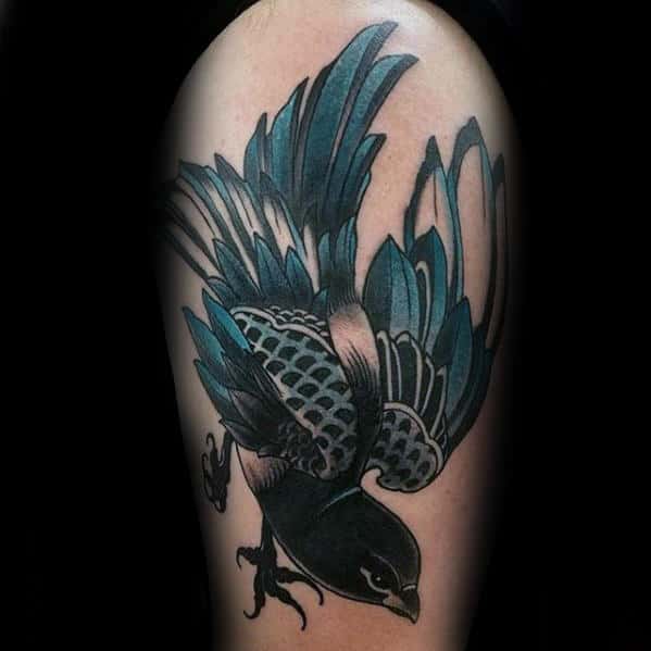 blue-and-black-ink-guys-traditional-bird-thigh-tattoo
