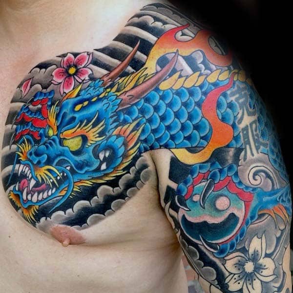 blue-flaming-japanese-dragon-guys-chest-tattoo