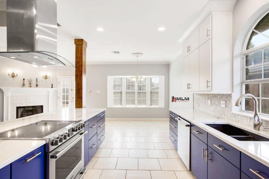 large galley kitchen blue and white cabinets tile floor