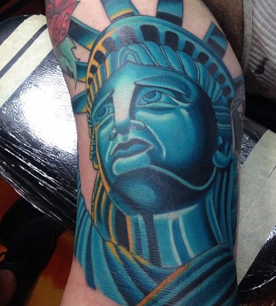 Blue Statue Of Liberty Tattoo On Mens Bicep
