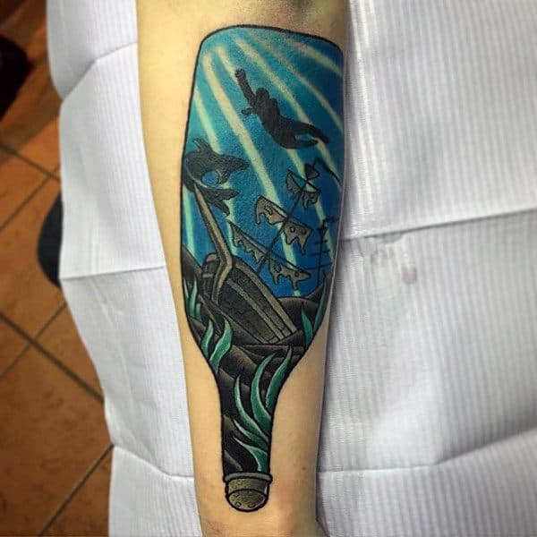 Blue Sunken Ship In A Bottle Tattoo On Mans Inner Forearm