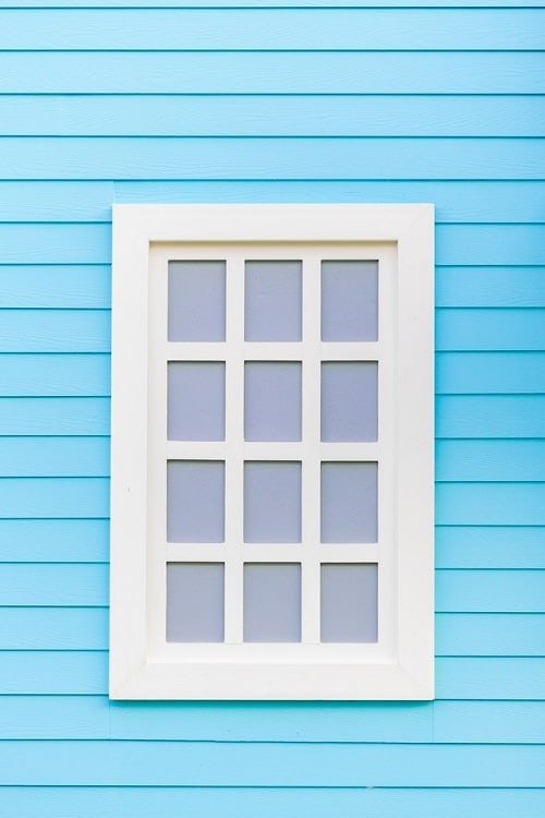 blue wall white wooden window trim