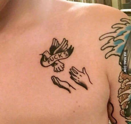A humorous black ink tattoo of a dove flying away with a banner reading 'F***S,' above two open hands as if releasing it.