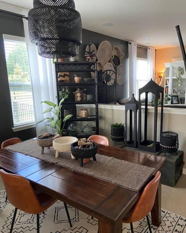 Boho dining room with dark walls, earthy decor, and a mix of textured items.