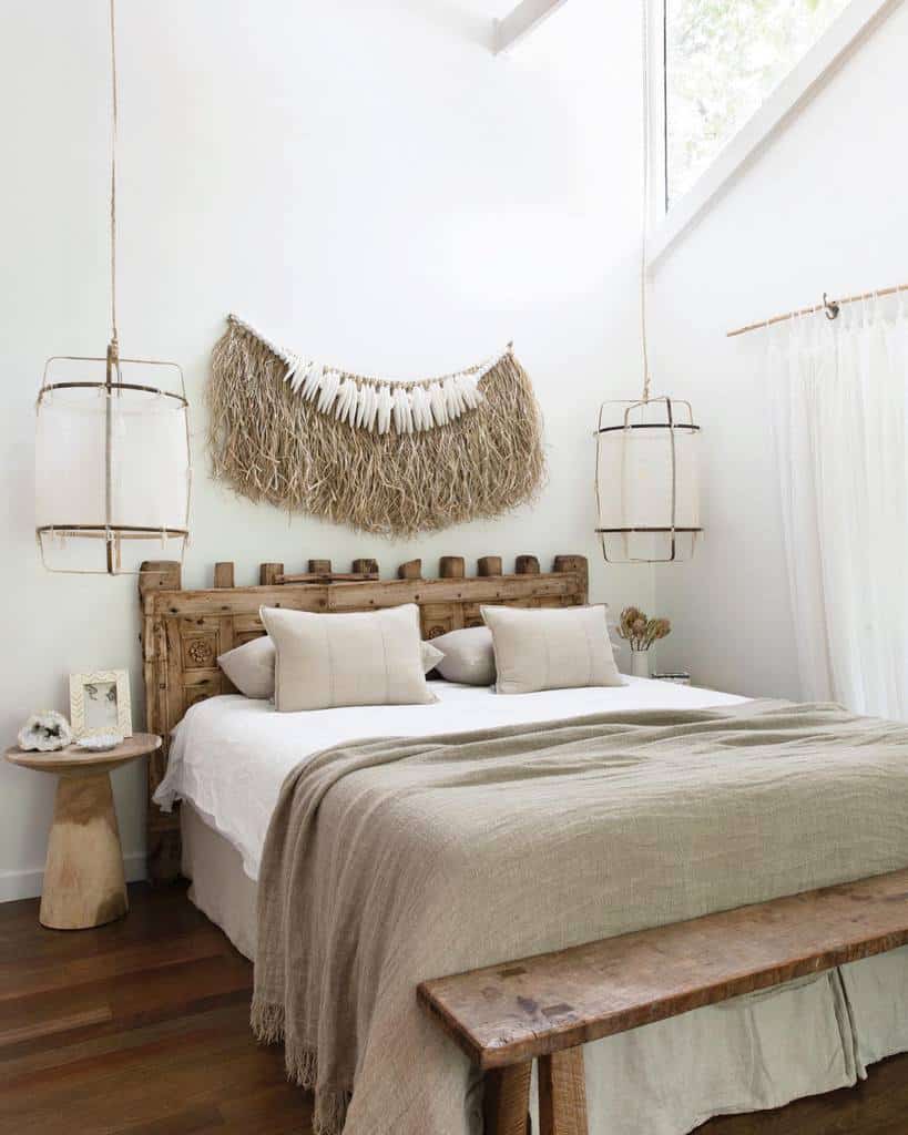 rustic boho bedroom with wood bed frame and ottoman