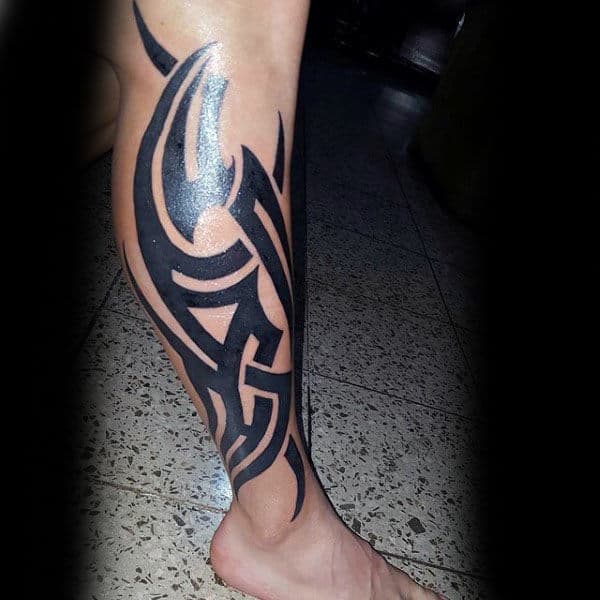 Bold Black Ink Tribal Tattoo On Males Leg