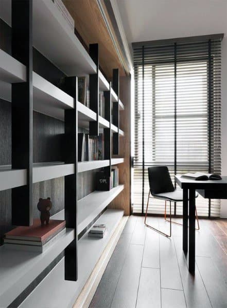 Modern study room with a tall, black-and-white bookshelf, a sleek desk, a chair, and large window blinds
