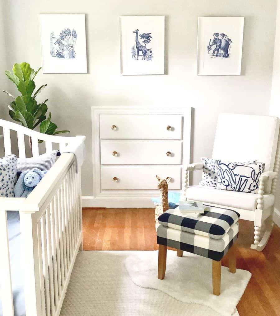 white and blue boys nursery room built-in wall drawers white crib and chair animal wall art