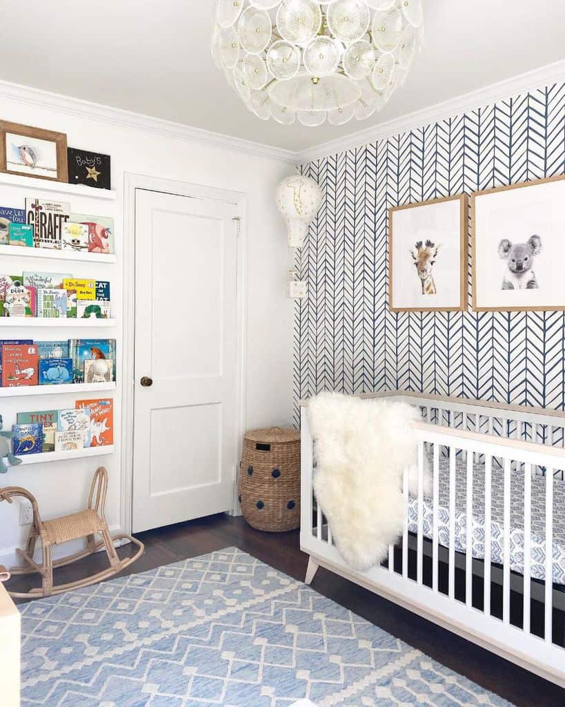 boys nursery blue and white pattern wallpaper wall mounted bookshelf white crib wicker basket