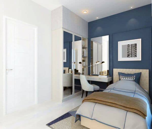Modern bedroom with navy accent wall, single bed, mirrored wardrobe, and cozy study nook.