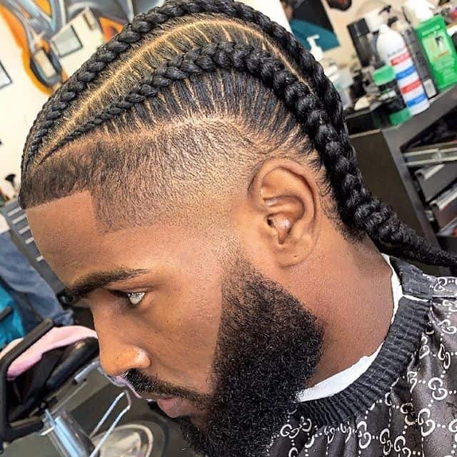 A burst fade haircut with four light braids and clean cut hairline