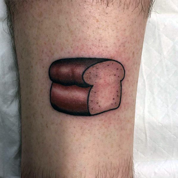 Realistic loaf of bread tattoo with bold shading and smooth gradients, giving it a three-dimensional look on the skin.