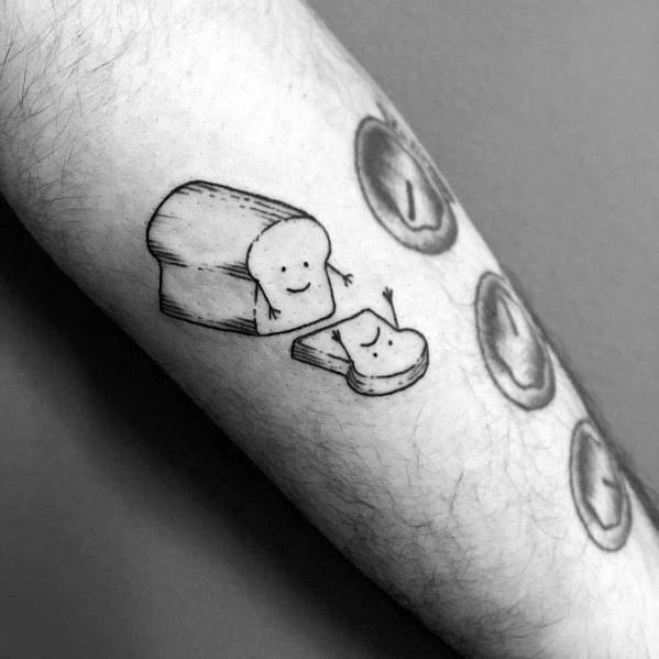 Cute black ink tattoo of a smiling loaf of bread with a happy toast slice, featuring a simple and playful hand-drawn style.