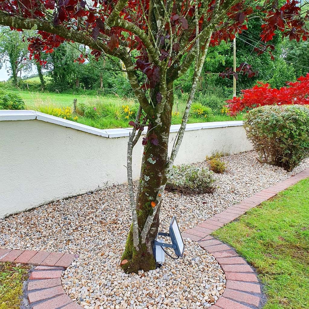 brick garden edging white concrete wall white stones