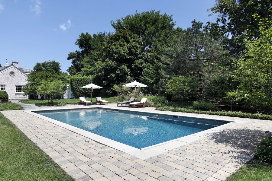 large paver pool deck with sun lounges