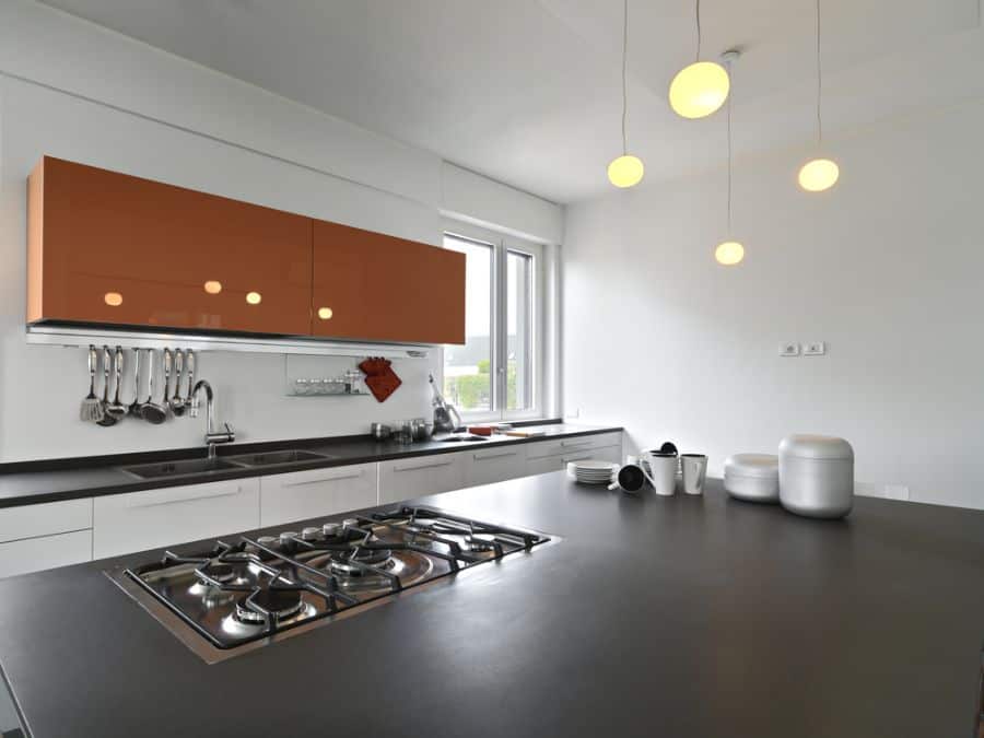 large modern kitchen with orange wall cabinet