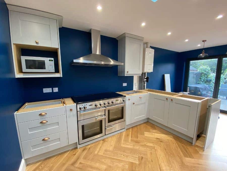 blue wall kitchen white cabinets