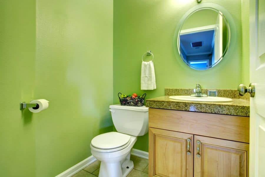 bright green bathroom with wood vanity 