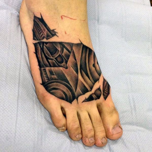 Foot with a detailed geometric black and grey tattoo on the top