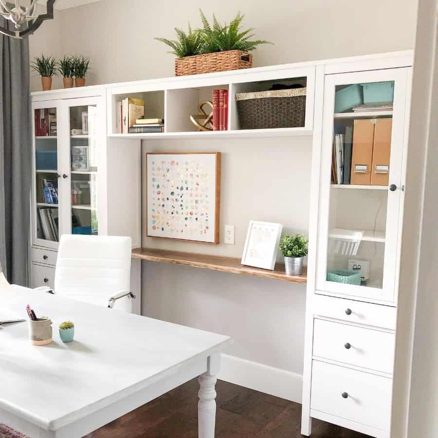 large built-in office cabinets and shelves pot plants large white desk