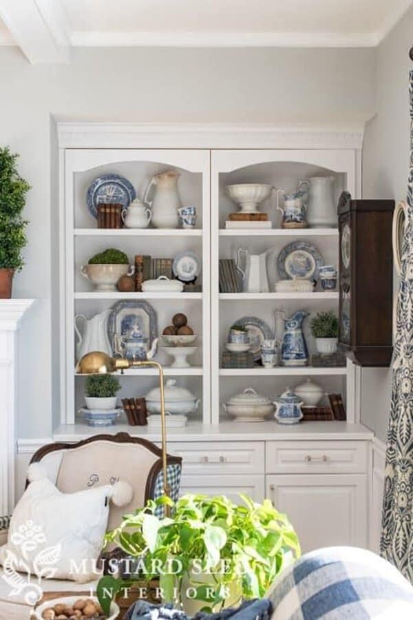 Classic built-in shelves showcasing blue and white china, vintage books, and decorative accents.