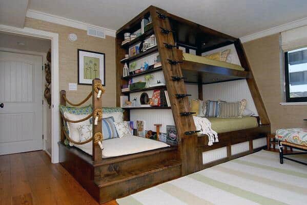 Cozy room with a wooden bunk bed featuring built-in shelves, pillows, and a charming reading nook