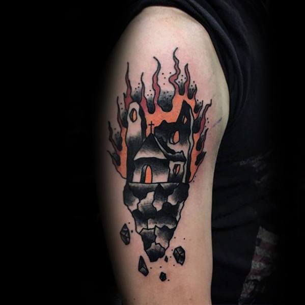 Burning church tattoo on a floating rock with black smoke and glowing orange flames. Surreal and bold design on upper arm.
