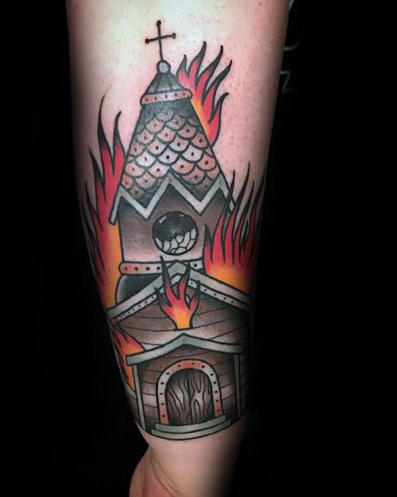 Traditional burning church tattoo with flames surrounding the steeple and doorway. Bold outlines and warm red-orange shading.