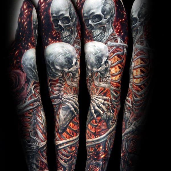 Full sleeve tattoo of fiery skeletons with glowing ribs and skulls, symbolizing death, inner fire, and the raw power of life and decay.