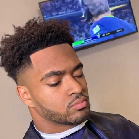 A burst fade style with medium hair taper and clean cut hairline