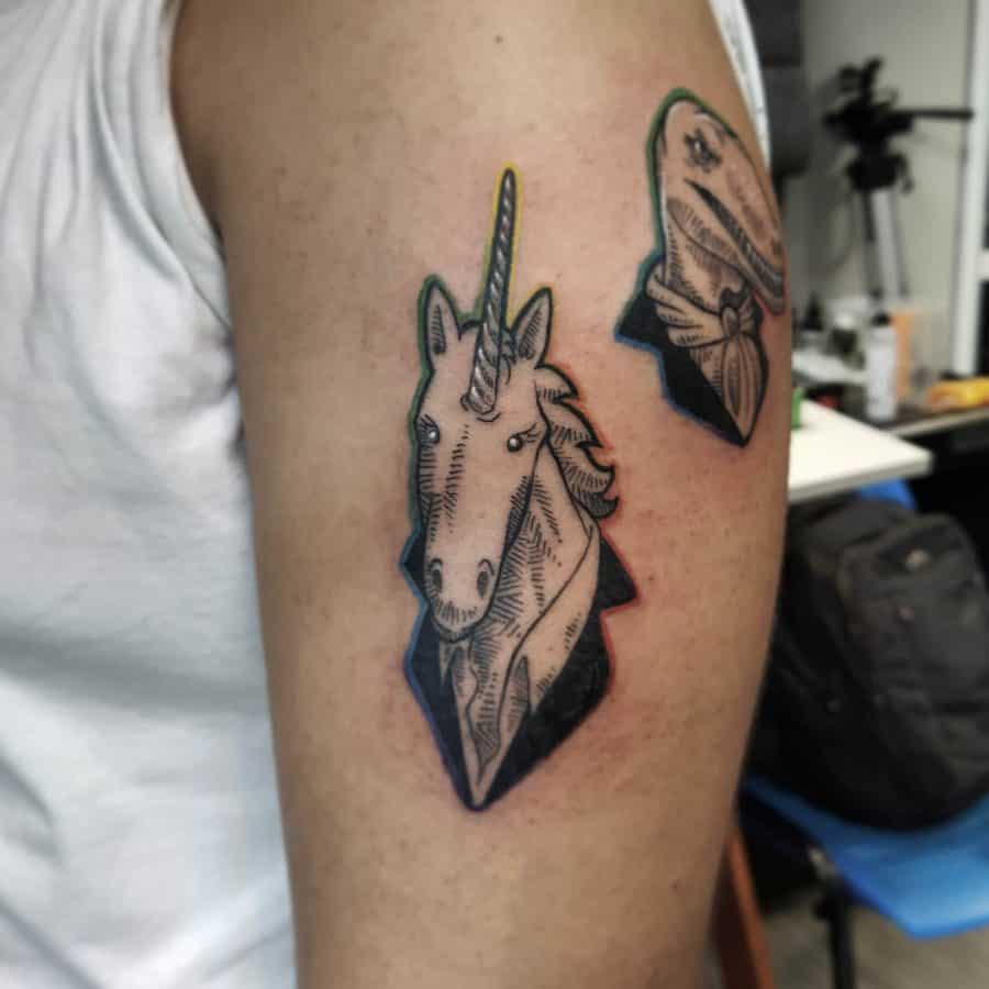 Black and grey tattoo of a unicorn wearing a bandana, paired with a similar dinosaur design, blending fantasy and vintage aesthetics.