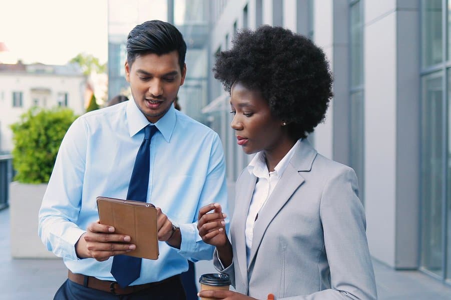 businessman showing something on tablet