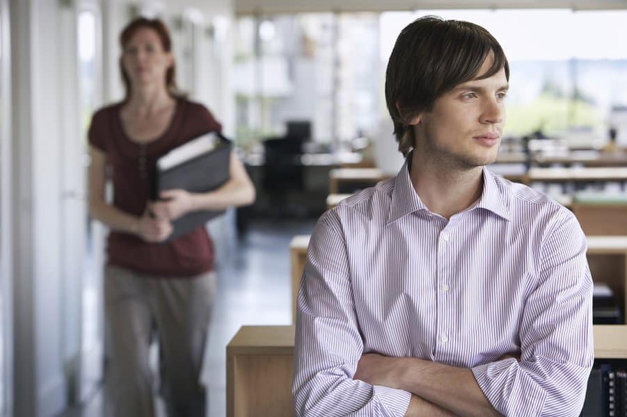 businessman with blurred female colleague in the background