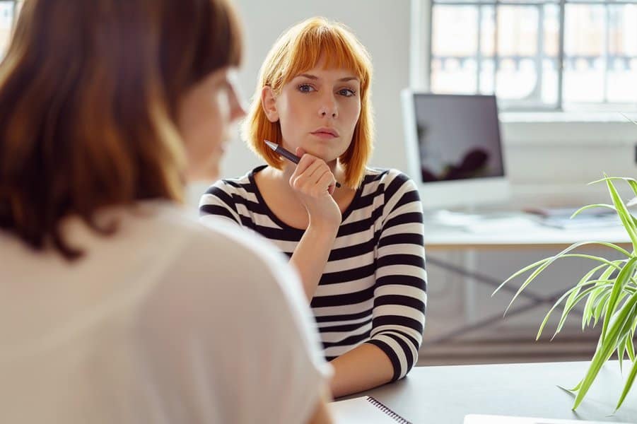 businesswoman watching her female colleague
